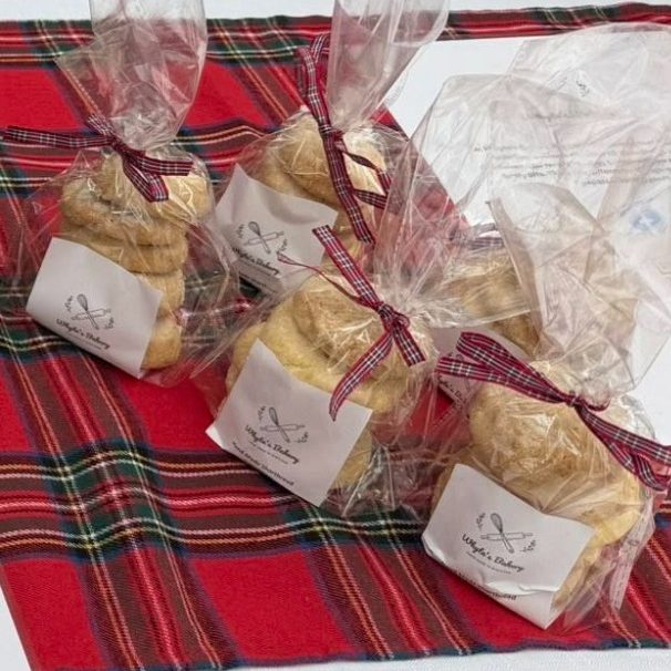 Whyte's Bakery traditional shortbread Bags of cookies tied with a ribbon on a red tartan tablecloth.