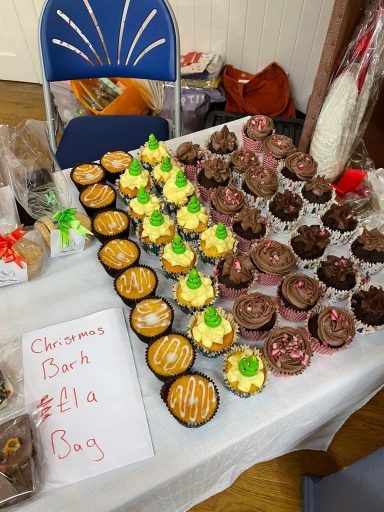 Whyte's Bakery Christmas Market A table display of assorted decorated cupcakes and baked goods.