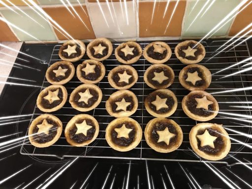 Mince Pies Whyte's Bakery Freshly baked mince pies arranged on a cooling rack with star-shaped pastry tops.